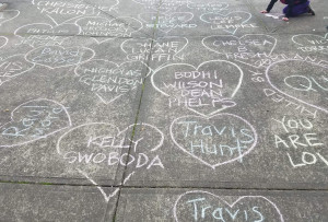 Sidelwalk chalk names of people killed by police from a protest outside PPB East Precinct in 2018
