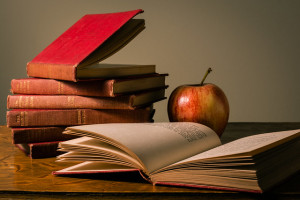 photo of red apple and books on desk