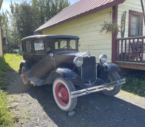 Old car in McCarthy, Alaska Image of a very old, restored car parked outside of a house