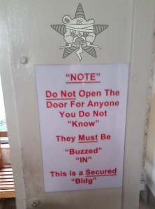 A sign alerting tenants that guests must be buzzed in