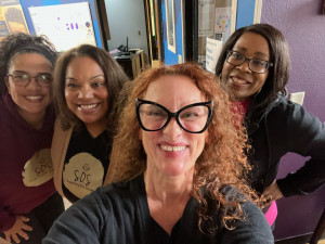 Supporting Our Society Four women smiling in radio station lobby