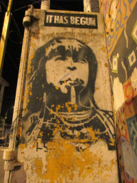 Stencil of Indigenous person with caption above them stating "It has begun".