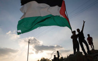 Children silhouetted holding Palestinian flag (image from http://www.tadamon.ca))